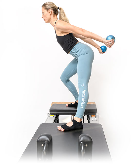 Laura Wilson demonstrating the Natural Pilates method on a reformer